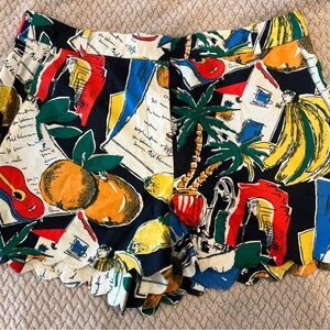 Festive luau print shorts with a scalloped edge on bottom